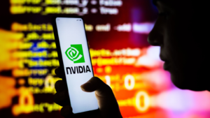 In this photo illustration, a woman holds a smartphone with the Nvidia Corporation (NVDA) logo displayed on the screen